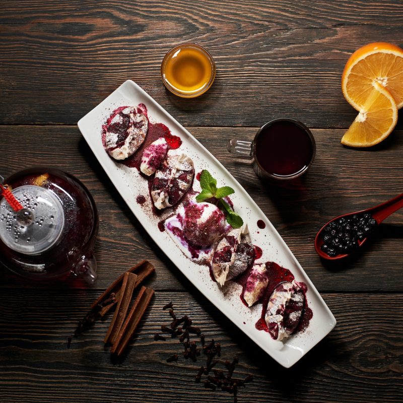 delicious-asian-dessert-in-long-white-plate-with-teapot-orange-berries-and-spices-.jpg